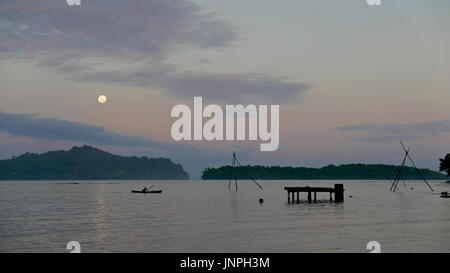 Fisherman in returning to his village at nightfall in Marovo Lagoon, World Heritage Site in Solomon Islands Stock Photo