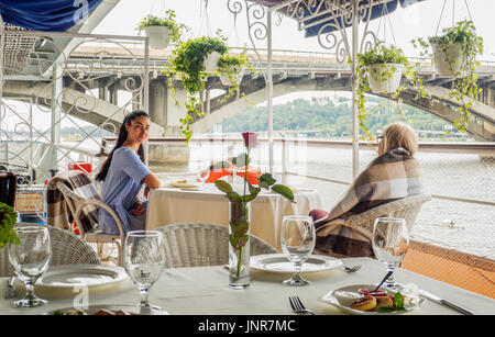 Food Set On The Deck With Woman In Background On A Yacht Sailing ... Food Set On The Deck With Woman In Background On A Yacht Sailing ...