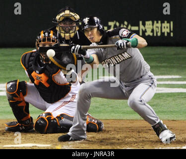 TOKYO, Japan - Nippon Ham Fighters infielder Makoto Kaneko (R) is greeted  by teammate Hiroshi Narahara after hitting a solo homer off Orix Bluewave  starter Edward Yarnall in the bottom of the
