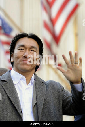 2009 World Series MVP Hideki Matsui, center, who wore the number 55 as a  member of the New York Yankees, is flanked by his father Masao, left, and  mother Saeko, as he