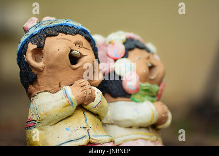 Smiling boy and girl statues show respect Stock Photo