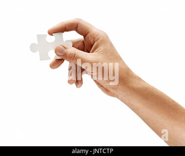 Man holding in hand puzzle element and looks for a solution to