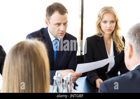 Business people discussing documents at workplace in office Stock Photo