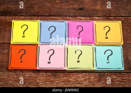question mark concept  - handwriting in black ink on colorful sticky notes against rustic wood Stock Photo