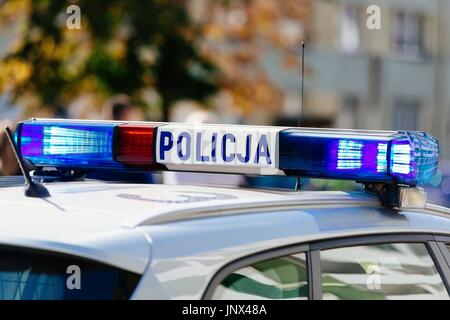 Flashing police blue lights mounted on the roof of Polish police car Stock Photo