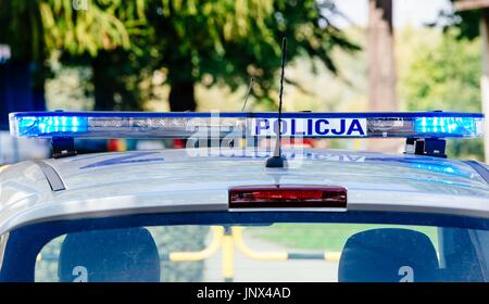 Flashing police blue lights mounted on the roof of Polish police car Stock Photo