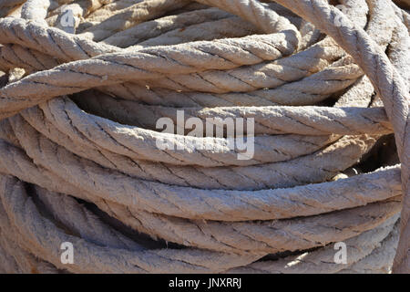 Coil of rope used for mooring a fishing boat in the port, Javea. Stock Photo