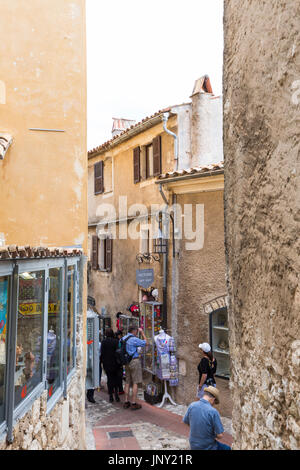 Eze, Alpes-Maritimes, France - October 11, 2015: Tourists in street in Eze, a quaint, well-preserved, old village on the Mediterranean in the Alpes-Maritimes department of France, popular with tourists. Stock Photo
