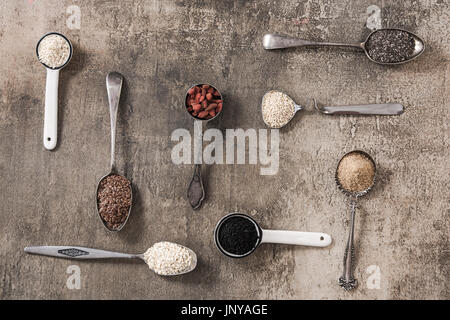 Superfood on spoons on stone slate background. Stock Photo