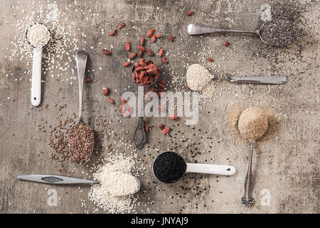 Superfood on spoons on stone slate background. Stock Photo