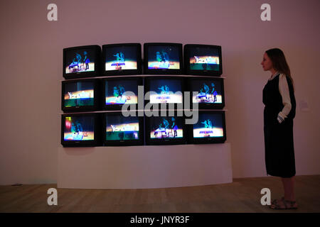 Museum staff looks at video installation - Violent incident 1986 - Video on 12 monitors in colours with sound. Preview of the new Artist Rooms exhibition of Bruce Nauman at Tate Modern, which will be on until July 2018. Nauman is widely regarded as one of the most innovative and influential American artists working today. The Artist Rooms gallery is the London hub for showcasing work from the Artist Rooms collection which is owned jointly by Tate and the National Galleries of Scotland. Credit: Dinendra Haria/Alamy Live News Stock Photo