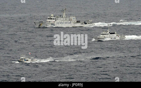 ISHIGAKI, Japan - Aerial photo taken by Kyodo News shows the Chinese maritime surveillance vessel Haijian 66 (back) sailing closer to a Japanese fishing ship (L, bottom), and the Japan Coast Guard patrol vessel Awagumo (R) around a border area of Japan's territorial waters, near the Japan-controlled Senkaku Islands, claimed by China, in the East China Sea at 10:06 a.m. on April 23, 2013. Eight Chinese maritime surveillance vessels entered Japanese territorial waters the same day around the Senkaku Islands, the Japan Coast Guard said. (Kyodo)