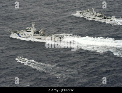 ISHIGAKI, Japan - Aerial photo taken by Kyodo News shows the Japan Coast Guard patrol ship Ishigaki (C) preventing the Chinese maritime surveillance vessel Haijian 66 (R, top) from sailing closer to a Japanese fishing ship (L, bottom) around a border area of Japan's territorial waters near the Japan-controlled Senkaku Islands, claimed by China, in the East China Sea at 10:09 a.m. on April 23, 2013. Eight Chinese maritime surveillance vessels entered Japanese territorial waters the same day around the Senkaku Islands, the Japan Coast Guard said. (Kyodo)