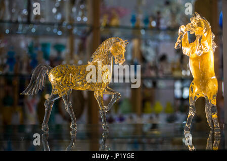 Murano, Venice, Italy - April 28, 2012: Glass horses in a glass shop on Murano, Venice, Italy. Murano glassmakers have led glass making in Europe for centuries. Stock Photo