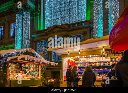 Brussels, Belgium - December 8, 2013: Christmas market booths in front of Stock Exchange building with lights in Brussels, Belgium Stock Photo