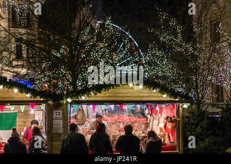 Ghent, Belgium - December 15, 2013: Market stall at Christmas market in front of the cathedral at night, Ghent, Belgium. Stock Photo