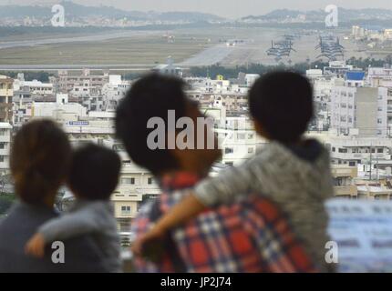NAHA, Japan - Photo taken Dec. 5, 2013 shows people viewing from an upland park the U.S. Marine Corps' Futenma Air Station in Ginowan, Okinawa Prefecture. (Kyodo)