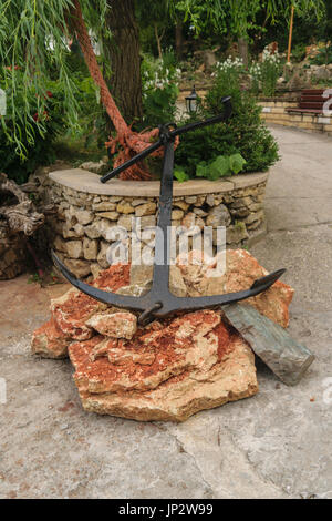 anchor on rocks for display purpose Stock Photo