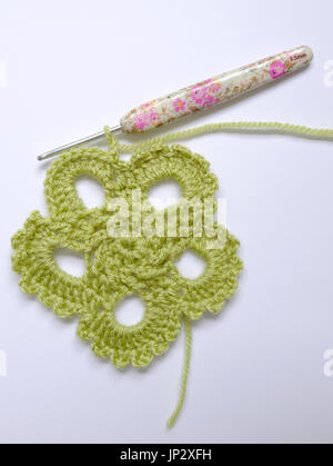 Work in progress on a green crocheted motif Stock Photo
