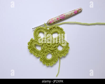 Work in progress on a green crocheted motif Stock Photo