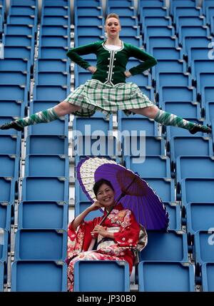 Highland Dancer Caroline Drummond from the Tattoo Dance Company with Michiko Matsunaga from Japan's Ground Self Defence Force Central Band as they perform in the stands on the Edinburgh Castle esplanade after the Royal Edinburgh Military Tattoo programme was revealed by Brigadier David Allfrey, chief executive and producer of the Tattoo. Stock Photo