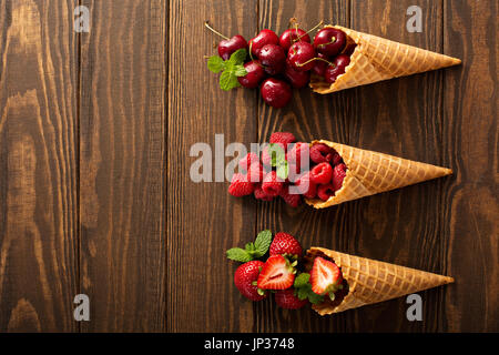 Fresh fruit and berries in waffle cones Stock Photo