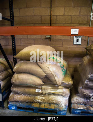 bags of raw coffee beans in the warehouse Stock Photo