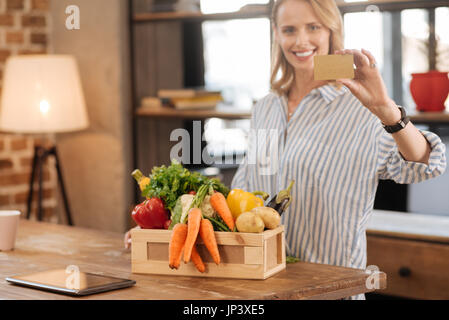 Clever young woman paying with her credit card Stock Photo