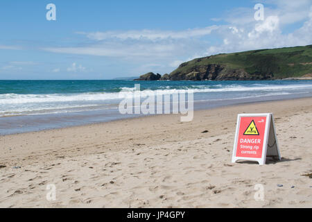 Danger strong rip currents sign on beach Stock Photo