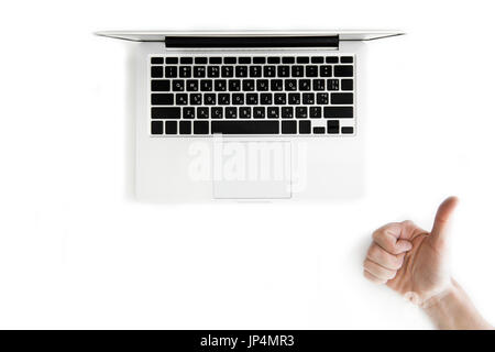 top view of human hand with thumb up and laptop computer isolated on white, wireless communication concept Stock Photo