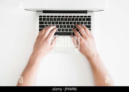 top view of human hands typing on laptop computer isolated on white, wireless communication concept Stock Photo