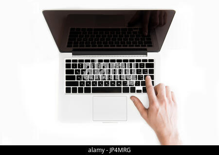 top view of human hand typing on laptop computer isolated on white, wireless communication concept Stock Photo