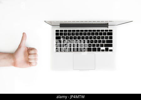 top view of human hand with thumb up and laptop computer isolated on white, wireless communication concept Stock Photo