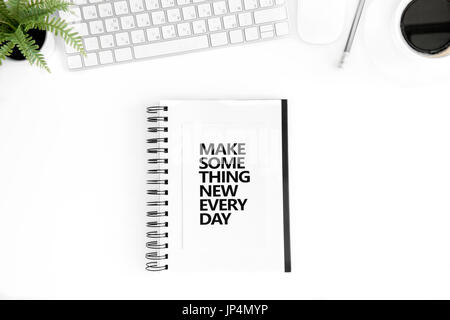 top view of make something new every day motivational quote in diary, computer mouse and keyboard isolated on white Stock Photo