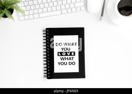flat lay with do what you love what you do motivational quote on diary, computer mouse and keyboard isolated on white Stock Photo