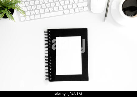 Top view of notebook with blank cover, cup of coffee, computer mouse and keyboard isolated on white Stock Photo