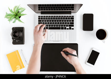 top view of hands using graphic tablet and laptop at workplace Stock Photo