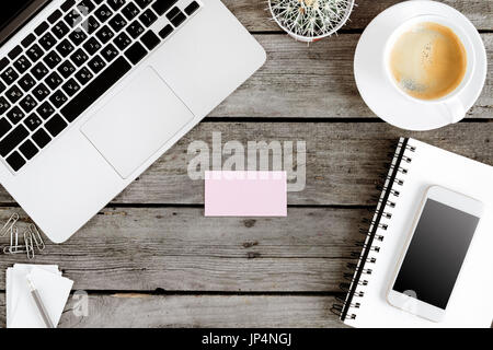 top view of wireless digital devices and blank card on workplace Stock Photo