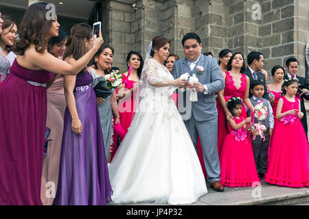 Philippine wedding party at Manila cathedral, Intramuros, Philippines Stock Photo
