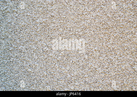 Old worn out tan stucco cement wall- texture or background Stock Photo