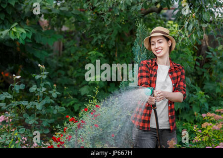 woman gardener watering garden Stock Photo