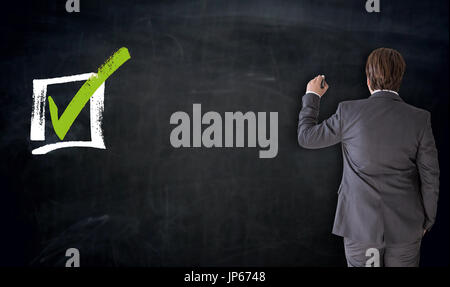 Businessman writing with checkbox concept on blackboard. Stock Photo