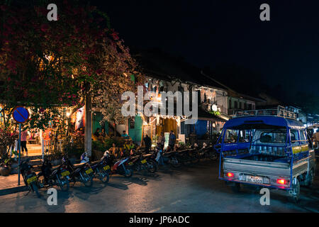 LUANG PRABANG, LAOS - MARCH 11, 2017: Night shoot of people inside of coffee shops and restaurants  at Sisavangvong Road, located in the olf Quarter o