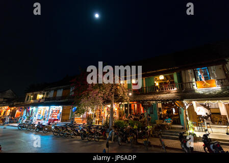 LUANG PRABANG, LAOS - MARCH 11, 2017: Night shoot over the moonlight of  coffee shops and restaurants at Sisavangvong Road, located in the olf Quarter