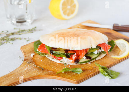 Salted salmon (sockeye salmon) with vegetables and feta in pita. Stock Photo