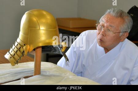 A chief priest of Kunozan Toshogu shrine in the central Japanese city of Shizuoka views on April 22, 2015, a warrior helmet thought to have been worn by Tokugawa Ieyasu, the first general of the Tokugawa shogunate of Japan, when he was a teenager. The shrine started mending the surface of the helmet, aiming to unveil it to the public one year later. (Kyodo) ==Kyodo