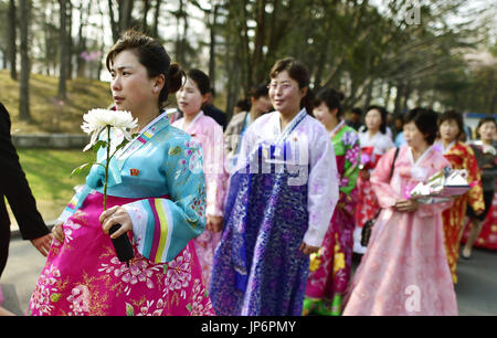 Women in chimajogori, traditional Korean jackets and skirts, walk to ...