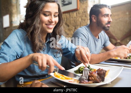 Couple having lunch at rustic gourmet restaurant Stock Photo