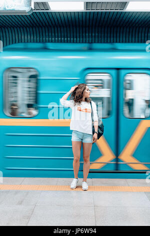 Beautiful young girl posing on metro station Stock Photo