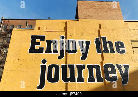 'Enjoy the journey' is painted on a wall in downtown Cleveland, Ohio, USA as part of a PR campaign for Akron-Canton Regional Airport. Stock Photo